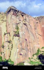 looking-up-at-millstone-edge-a-sheer-cliff-face-jutting-out-of-the-D9XPAP.jpg